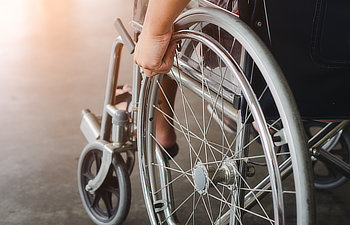 disabled man is sitting in a wheelchair he holds his hands on the wheel handicap Martinez, GA