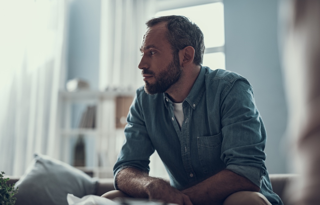 calm bearded middle aged man sitting at home and thoughtfully looking into the distance Martinez, GA